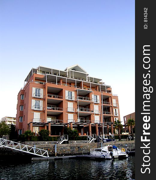Portrait photo of luxury residential unit from canal. Portrait photo of luxury residential unit from canal.
