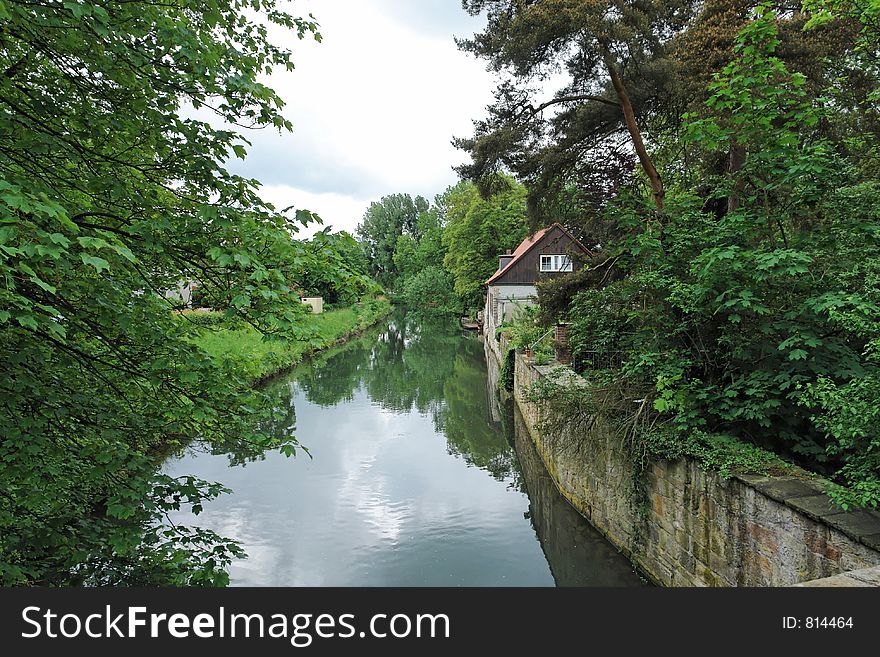An idyllic river scene in nothern Germany on a cloudy and cold day in May. An idyllic river scene in nothern Germany on a cloudy and cold day in May.