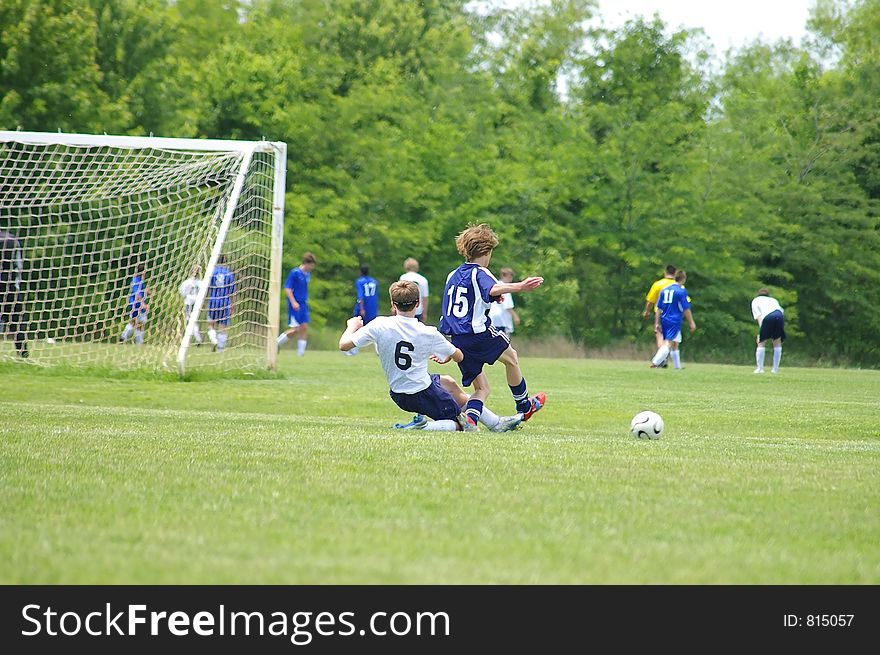 Soccer slide tackle action shot