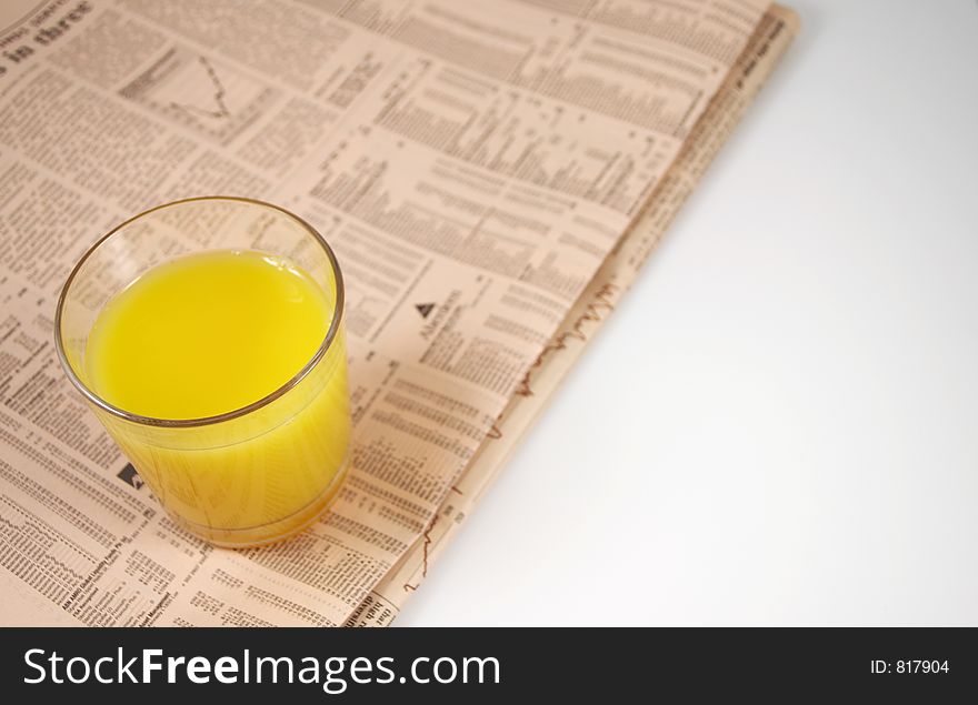 Glass Of Orange On Newspaper