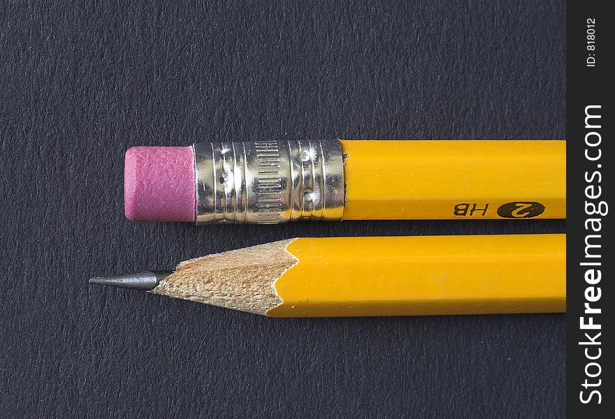 A pencil and an eraser on black background. A pencil and an eraser on black background