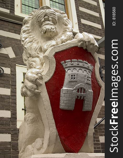 Statue of lion with bright red coat of arms. Statue of lion with bright red coat of arms
