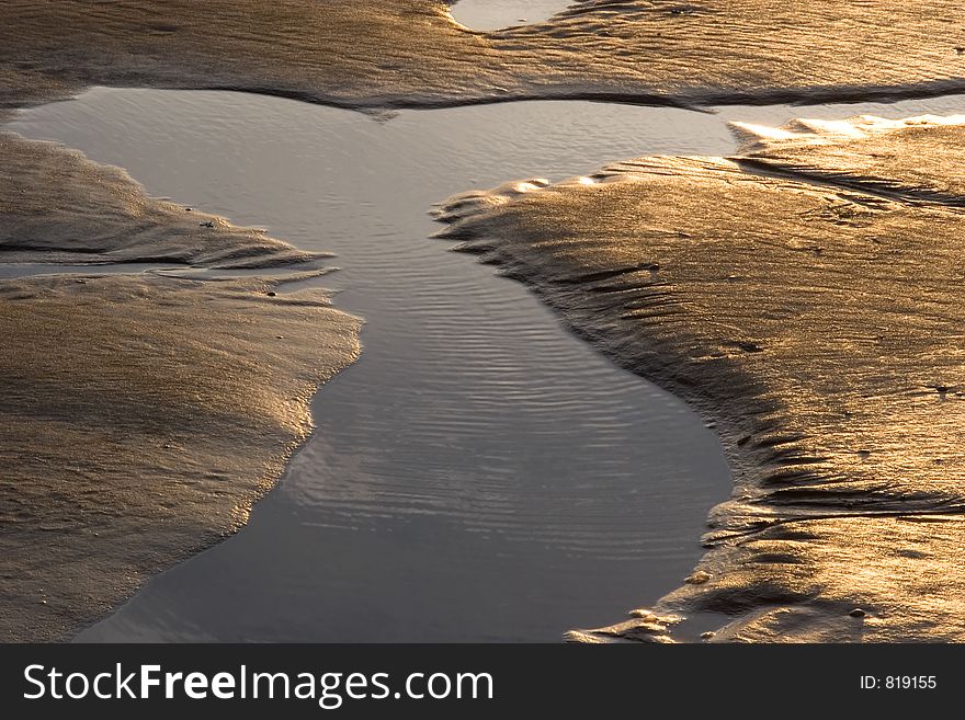 Sand forms created by the tide on a beach. Sand forms created by the tide on a beach