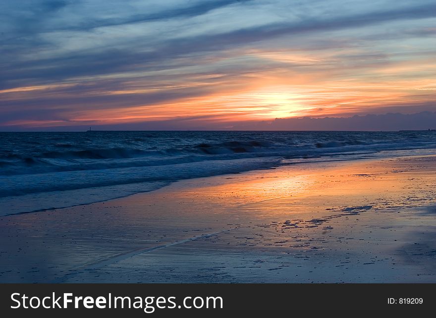 Sunset with warm colors of a mediterranean sea bech. Sunset with warm colors of a mediterranean sea bech