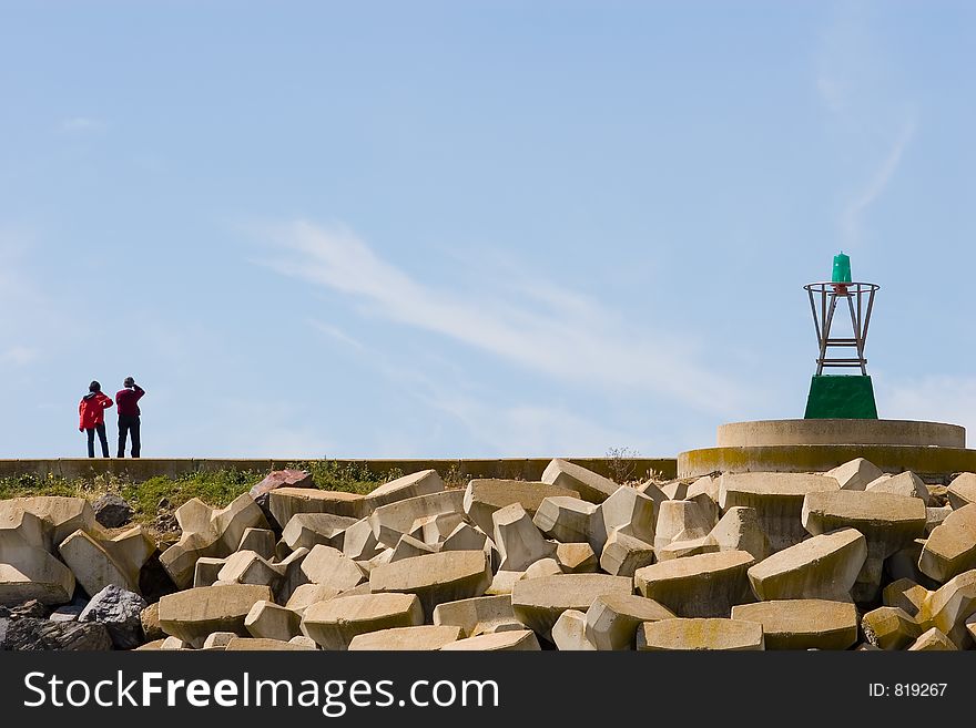 A couple looking at the sea in a dock