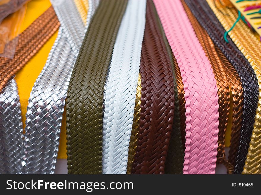 Lots of belts in a street market