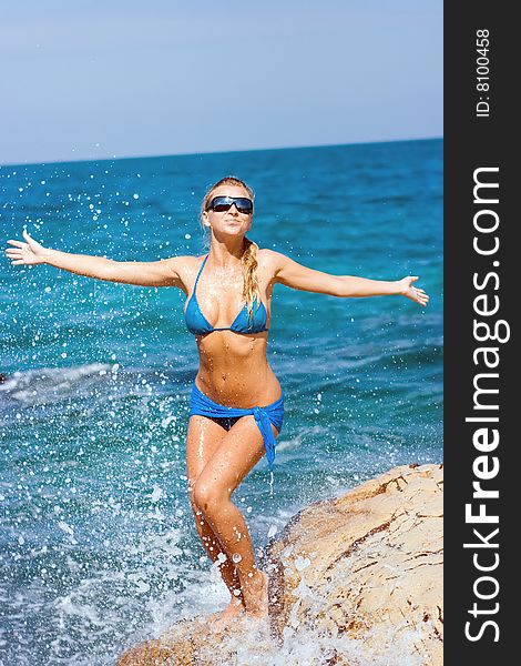 Beautiful blond girl flying on sea waves. Beautiful blond girl flying on sea waves