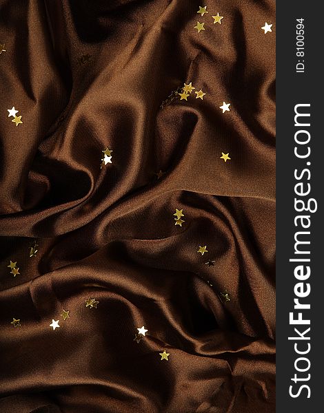 Brown textile background with little golden stars. Brown textile background with little golden stars
