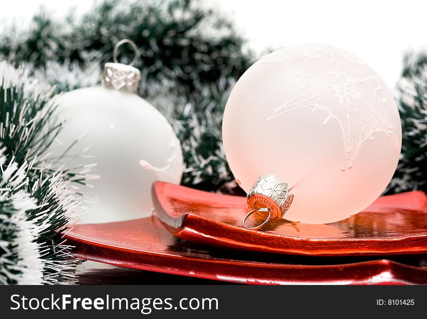 Christmas balls in plate and garland