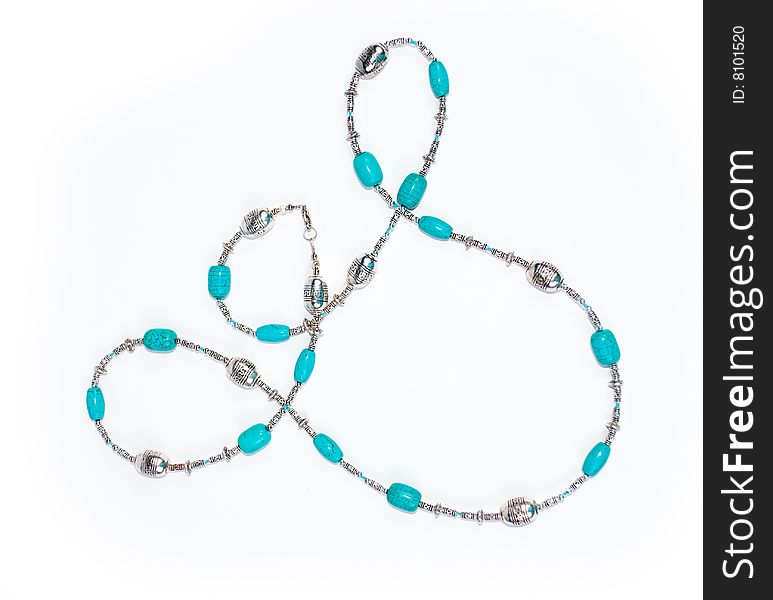 Blue beads on white background with turquoise