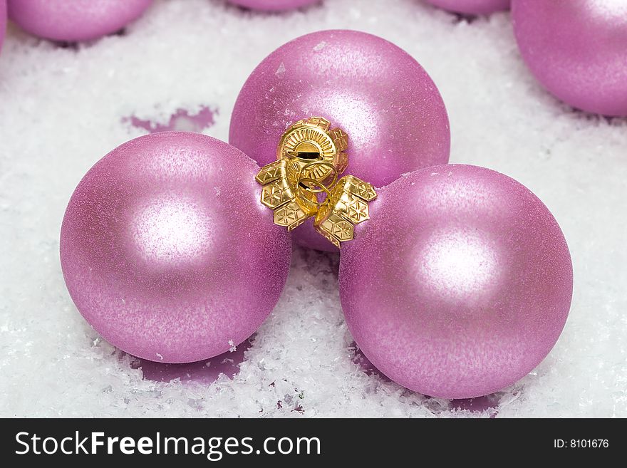 Pink Christmas balls in snow