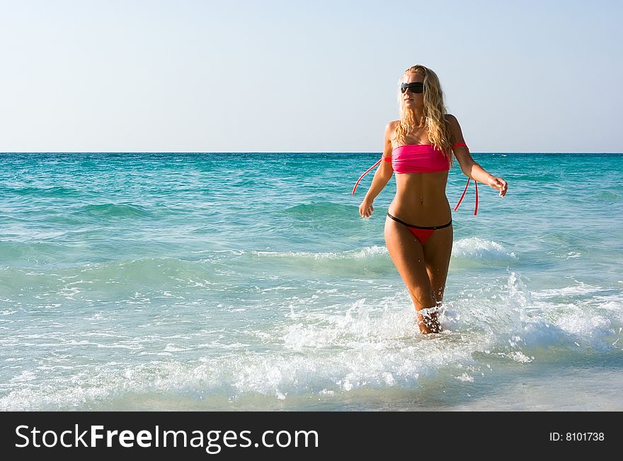 Beautiful blond girl going out of the sea. Beautiful blond girl going out of the sea