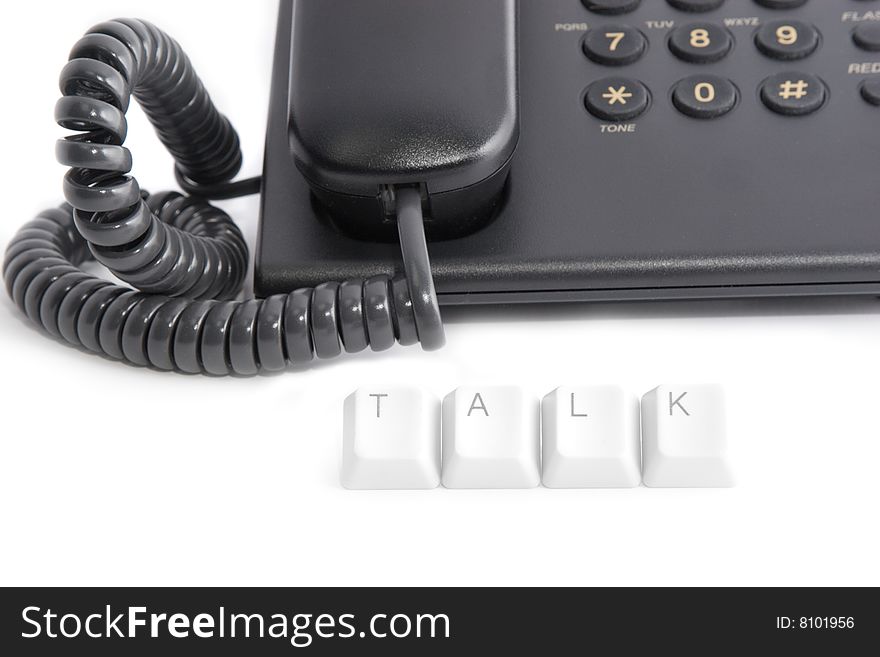 Phone talk: black office telephone and TALK caption