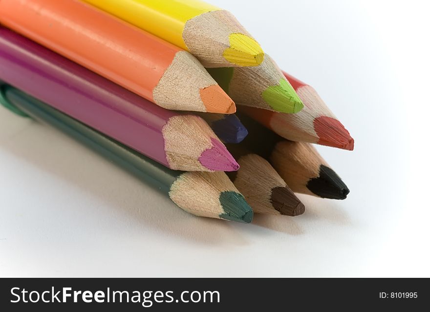 Colored pencil crayons on white background