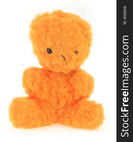 A very old orange teddy bear on white background