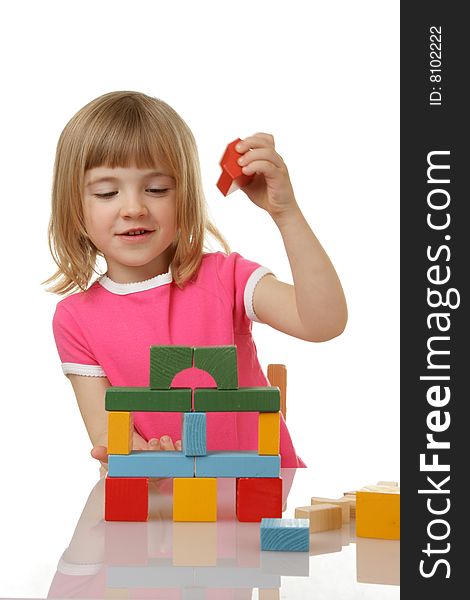 Beautiful little girl playing with cubes