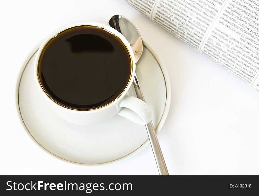 Cup of coffee and newspaper on white background