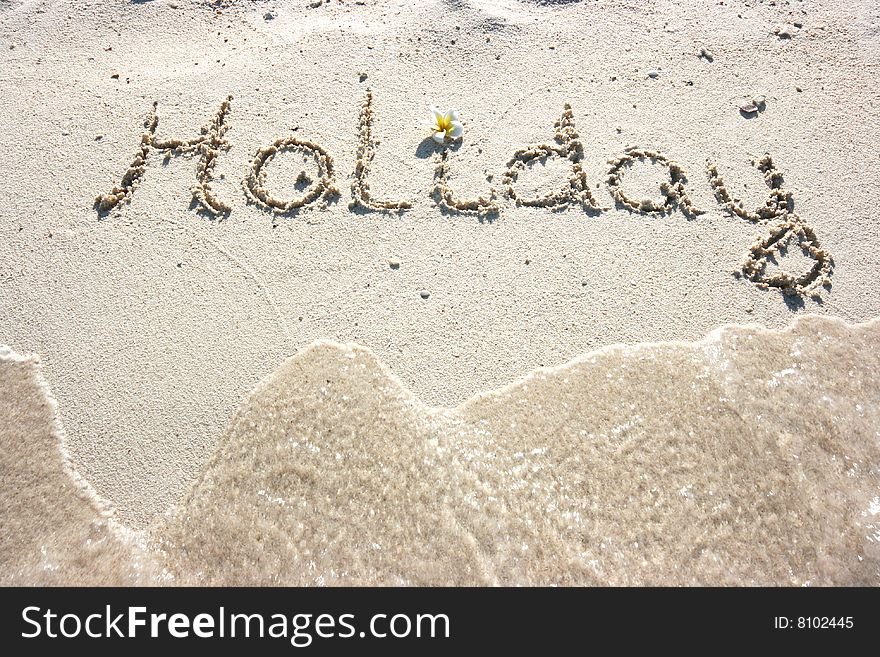 Holiday inscription on the sand beach. Holiday inscription on the sand beach