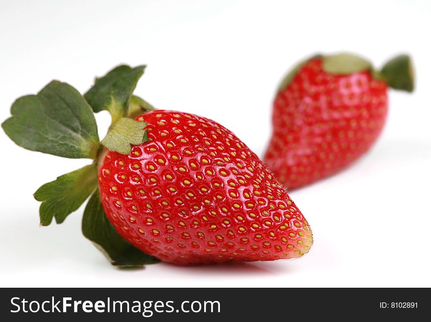 Two Delicious red strawberries isolated