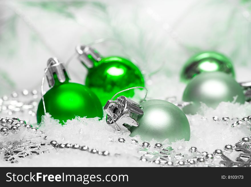 Green festive decoration on snow