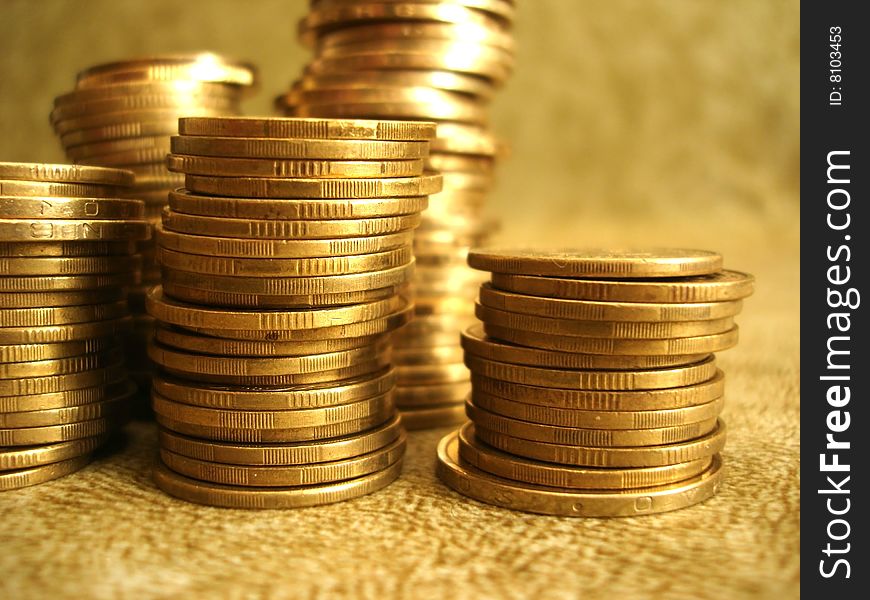 Stack of golden coins on yellow background