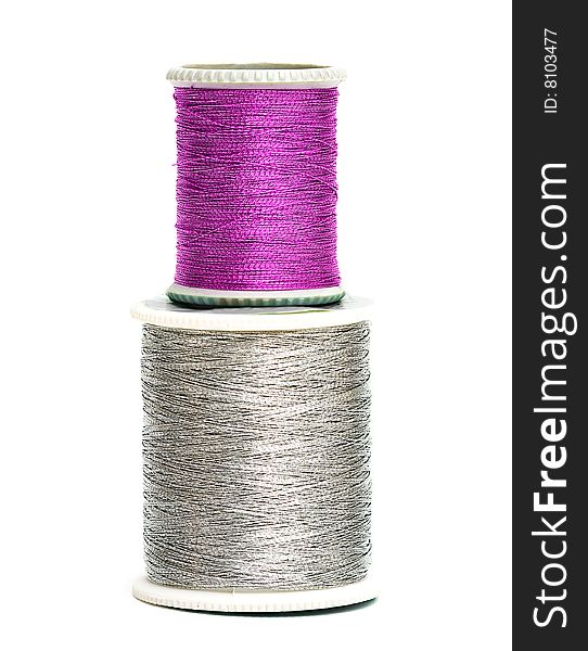 Pink and silver spools of threads