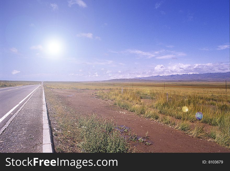 It is a straight road to destination with bright sun.location is in china.