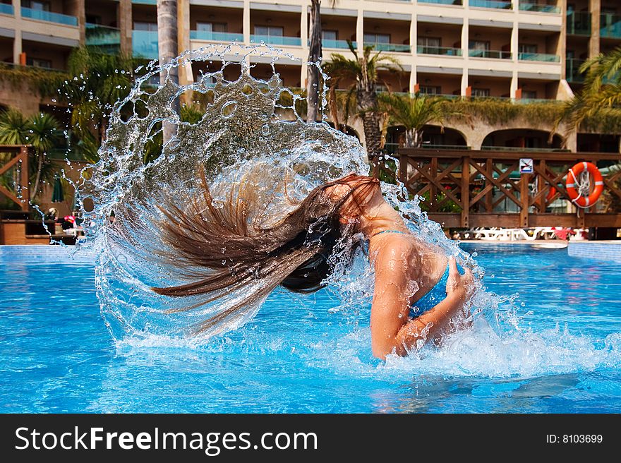 Young woman playing in the swimming pool. Young woman playing in the swimming pool