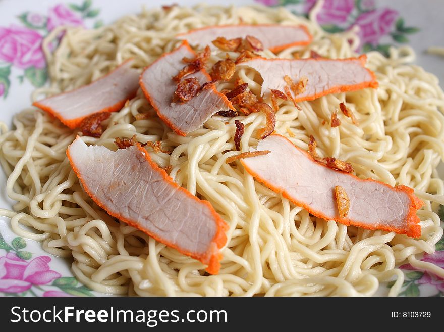 Closeup of Kampua mee (Sarawak Chinese noodles) with roasted pork meat.