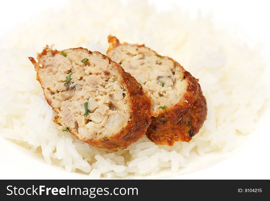Chicken roll pieces put on white rice.