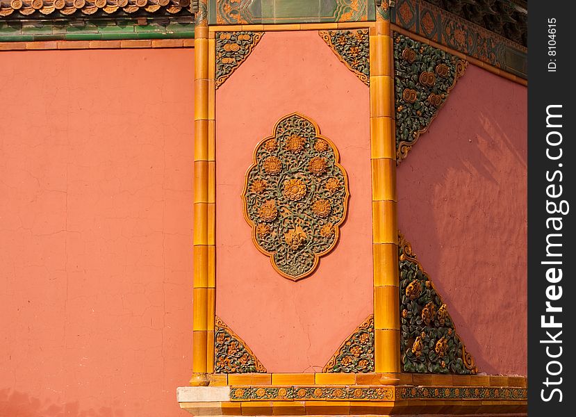 Golden relief on red wall in forbidden city