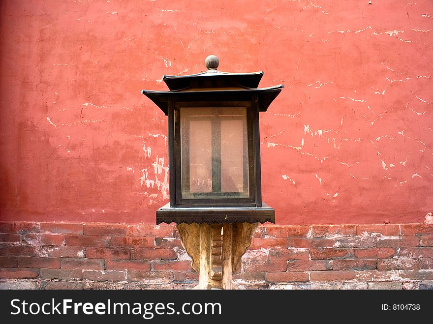 Antique wood lamp beside red wall of the forbidden city. Antique wood lamp beside red wall of the forbidden city