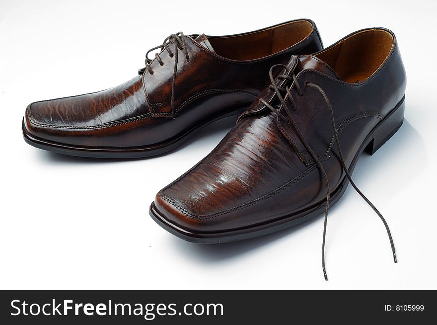 A pair of traditional brown brogue shoes isolated on white