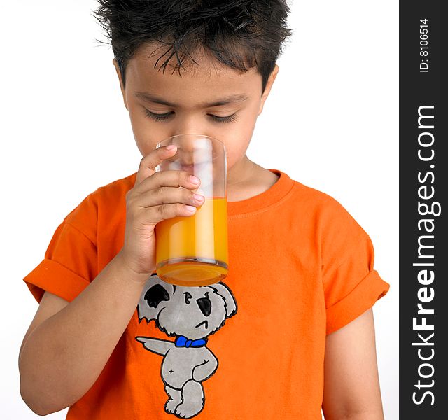 Indian Boy Drinking A Glass Of Juic