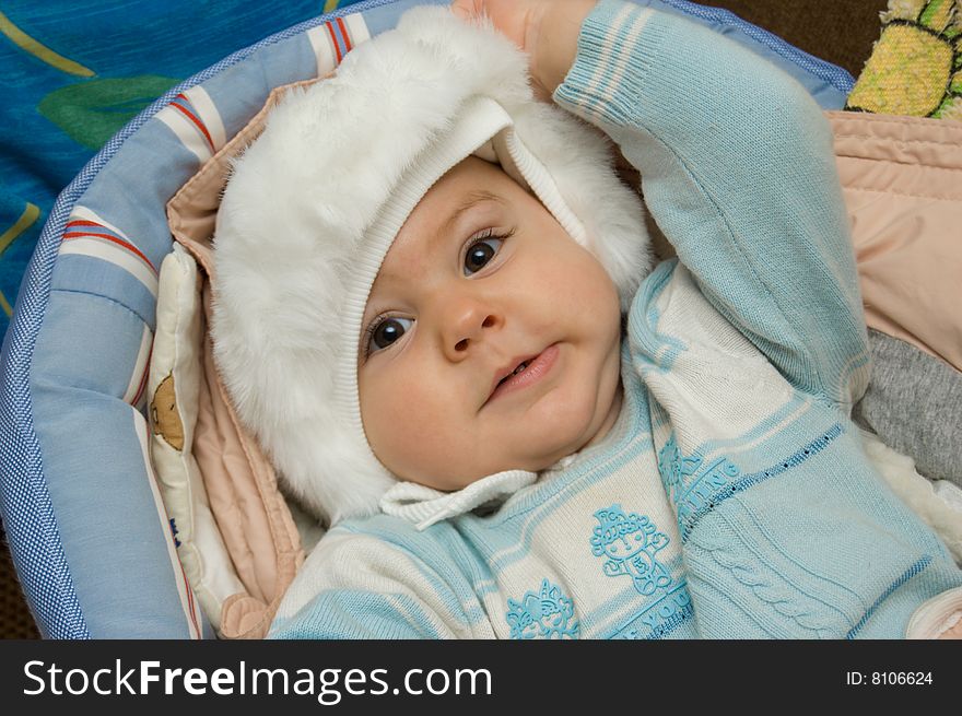 Baby taking off his hat