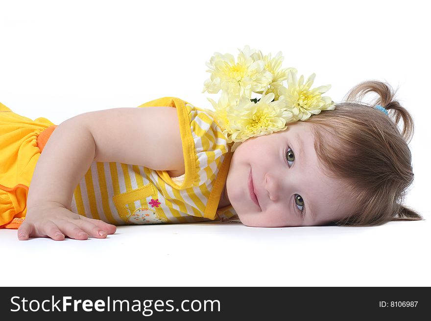 Funny little girl relaxing with yellow flowers