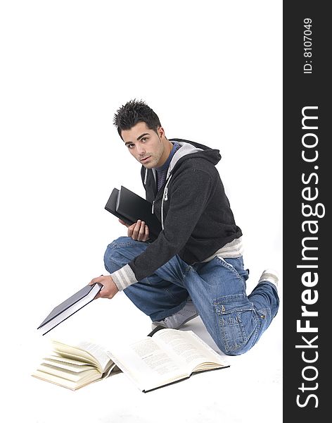 Young man with a lot of books on the floor