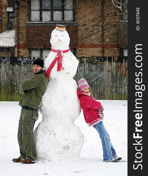 Dad and Daughter with Snowman