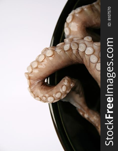 Octopus tentacles on a black dish