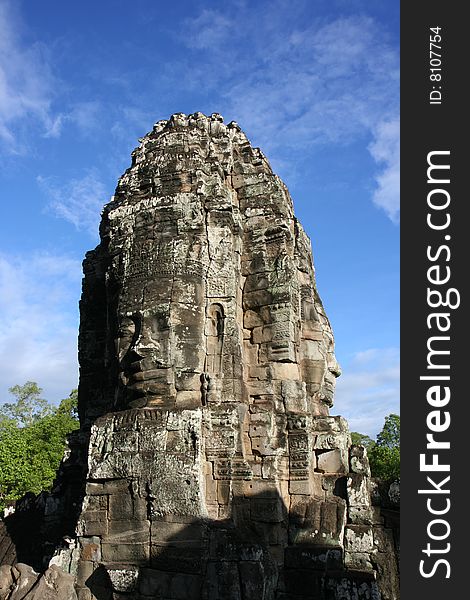 Face carved in rock at Bayon Temple at Angkor in Cambodia. A temple from the 12th century. Face carved in rock at Bayon Temple at Angkor in Cambodia. A temple from the 12th century.