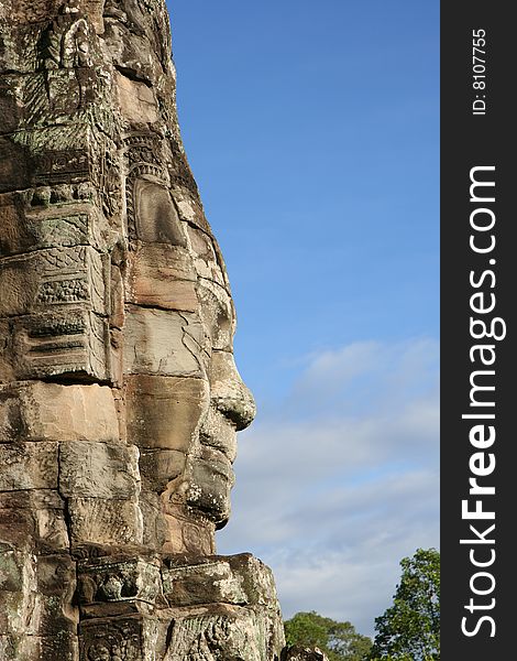 Face carved in rock at Bayon Temple at Angkor in Cambodia. A temple from the 12th century. Face carved in rock at Bayon Temple at Angkor in Cambodia. A temple from the 12th century.