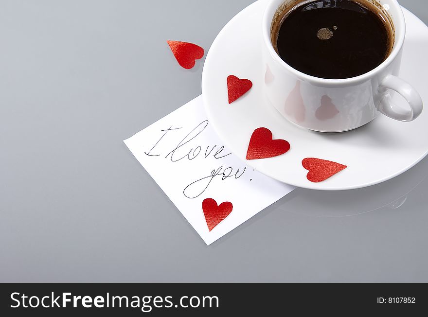 Cup with hot coffee, hearts and a note. Cup with hot coffee, hearts and a note