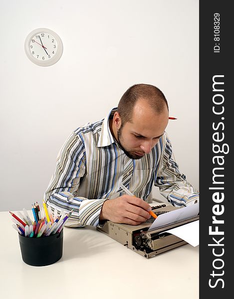 Man typing a document on an antique typewriter in an office. Man typing a document on an antique typewriter in an office