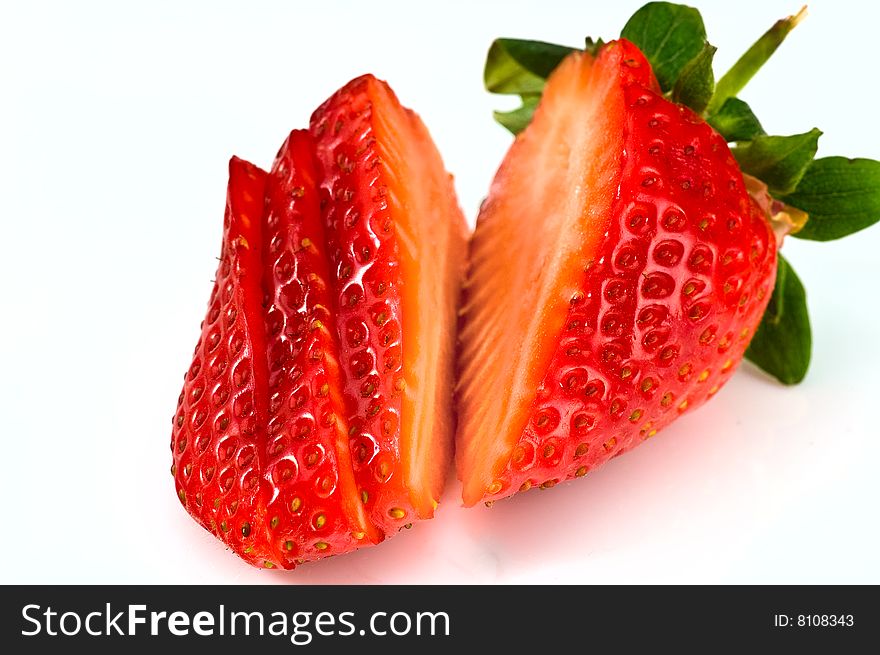 Fresh ripe strawberry cutted into pieces on white background. Fresh ripe strawberry cutted into pieces on white background