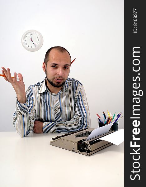 Man typing a document on an antique typewriter in an office. Man typing a document on an antique typewriter in an office