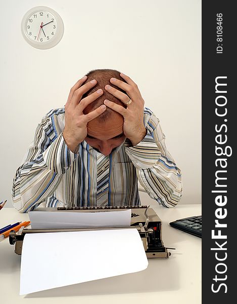 Man typing a document on an antique typewriter in an office. Man typing a document on an antique typewriter in an office