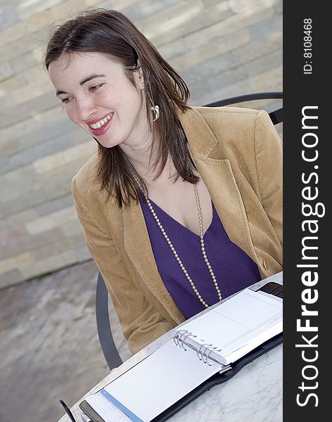 Young business woman with notes book in front of her