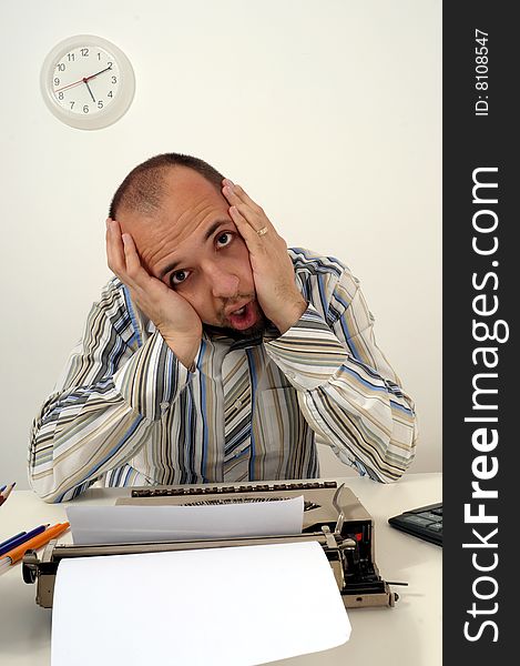 Man typing a document on an antique typewriter in an office. Man typing a document on an antique typewriter in an office