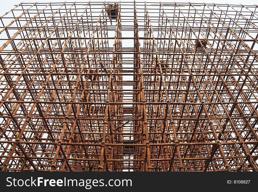 The rusty iron pole upward in the sky in a construction site. The rusty iron pole upward in the sky in a construction site.