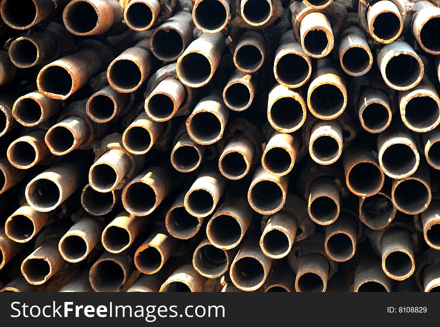 The rusty iron tubes background in the construction site. The rusty iron tubes background in the construction site.